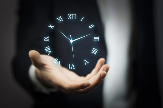 IreriBusinessman hand holding clock