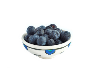 Fresh blueberries in bowl isolated on white.