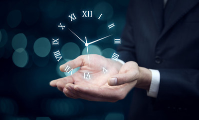 IreriBusinessman hand holding clock