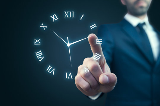 IreriBusinessman hand holding clock