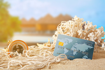 Sand with credit card and coral on white background