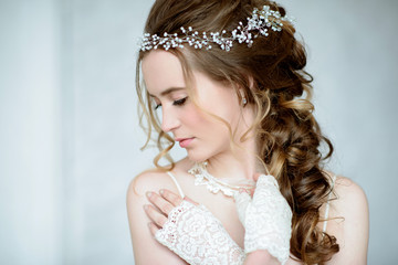 Closeup brunette bride with fashion wedding hairstyle and makeup
