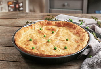Baked chicken pot pie on wooden table
