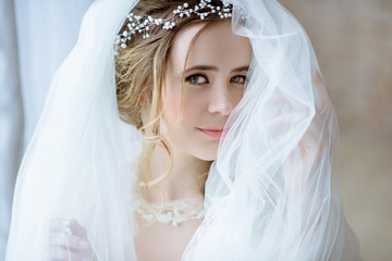 Closeup brunette bride with fashion wedding hairstyle and makeup