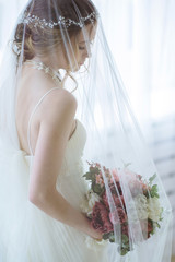 Brunette bride in fashion white wedding dress with makeup