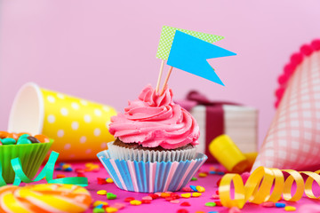 Tasty cupcake with flags on colorful background