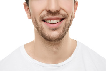 Young handsome man smiling on white background