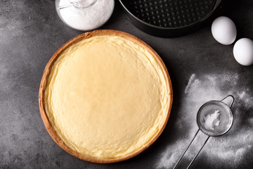 Composition with tasty cheesecake on grey table