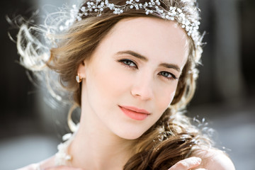 Closeup brunette bride with fashion wedding hairstyle and makeup