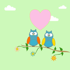 Owls on a branch of a tree