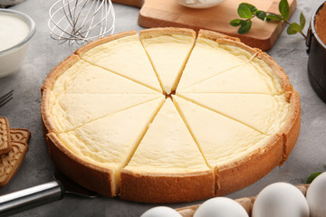Tasty homemade cheesecake on grey table, closeup