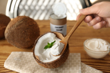 Coconut cream in wooden spoon, closeup