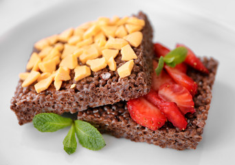 Chocolate crispy dessert with strawberry on plate
