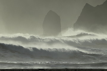 Reynisdrangar Sea Stacks, Iceland waves breaking on Renisfjara beach in front of the Reynisdrangar...