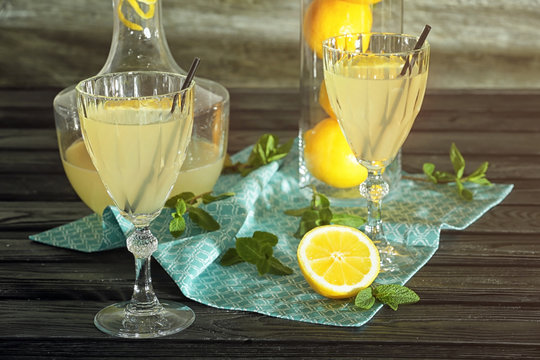 Delicious lemon juice in glasses on kitchen table