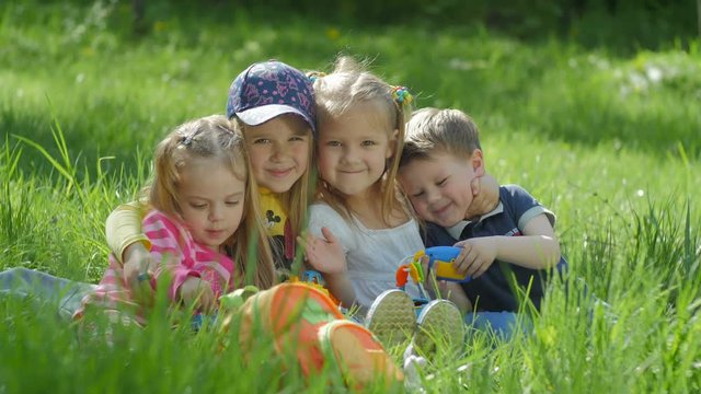Group of happy smiling children playing outdoors in spring park