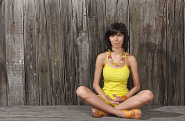 Young woman sitting on wooden desk