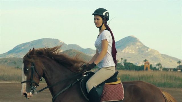 Girl galloping on a horse in Spain.