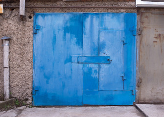 view of the garage with the blue gate