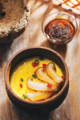 Steamed eggs with meat in hot bowl