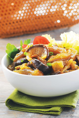 White bowl of sauteed mushroom with stir fried beef
