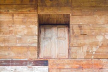 wood texture background from the wall of house in asia with vintage window in the middle