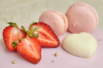 Pink mousse cake mirror glaze, decorated with macarons and strawberry