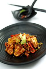 Sauteed beef with spices on black platter