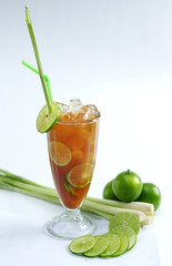 Glass of fresh lime tea with lemongrass on white background