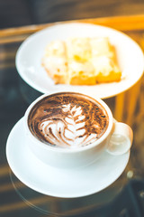 Hot chocolate art with coffee cup and ham cheese bread