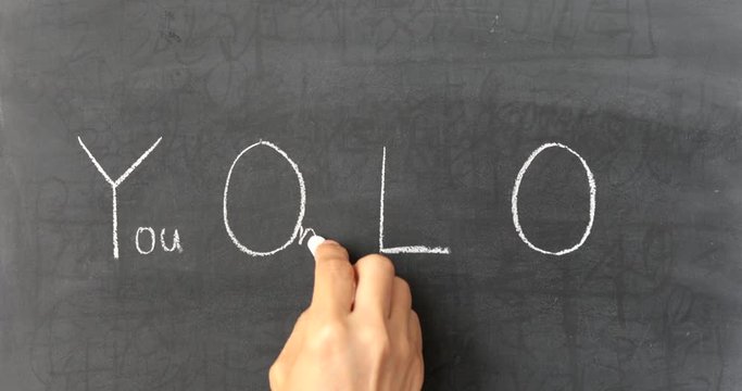 Chalk writing - You Only Live Once on chalkboard 