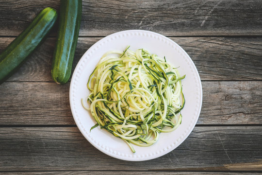 Zucchini Noodles over a wooden table