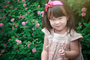 happy little girl in flower field