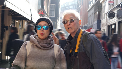 Asian senior couple lost in Europe. Travel after retirement and get confuse during the trip