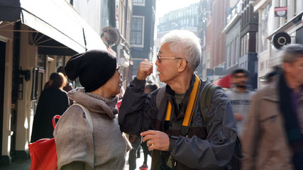 Asian senior couple lost in Europe. Travel after retirement and get confuse during the trip