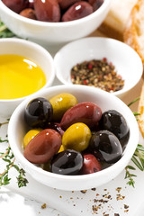 fresh organic olives, spices and bread, closeup vertical