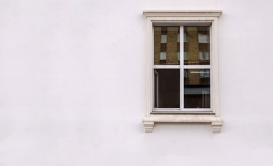 Fototapeta na wymiar Beautiful window on white plaster wall