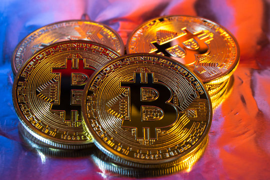Cryptocurrency physical golden bitcoin coin on colorful background