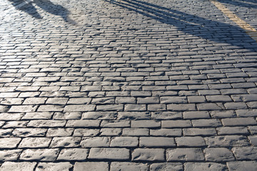 Shadows on pavement, cobblestone, path concept, perspective