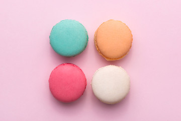 Colorful pastel cake macaron or macaroon on pink background from above