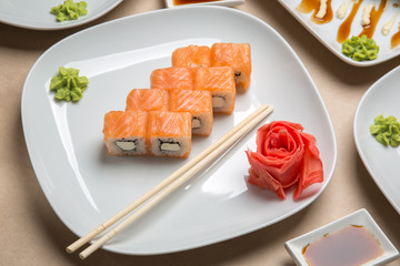 delicious rolls with salmon and ginger on a white plate in a restaurant