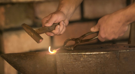 Smith working with iron in the forge