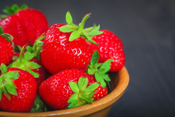 Ripe strawberries in a plate close-up.