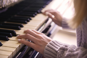 Fototapeta premium Female hands playing piano