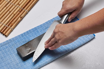 Fototapeta na wymiar Handle the knife to make a sharp knife with a whetstone.