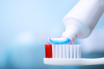 Toothpaste squeezed from tube onto brush, close up