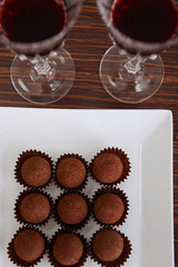 Wine and chocolates on wooden background
