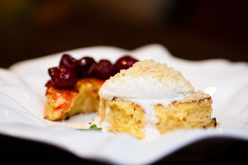 Dessert of cake, ice cream and cherries.