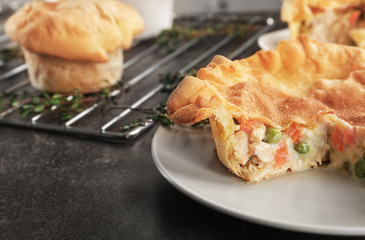 Plate with delicious chicken pot pie on kitchen table