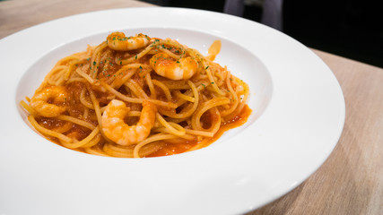 Spaghetti shrimp sauce in modern italian restaurant.